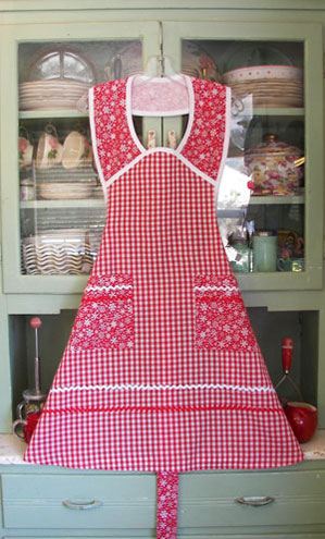 Red gingham Christmas apron with snowflakes on the pockets